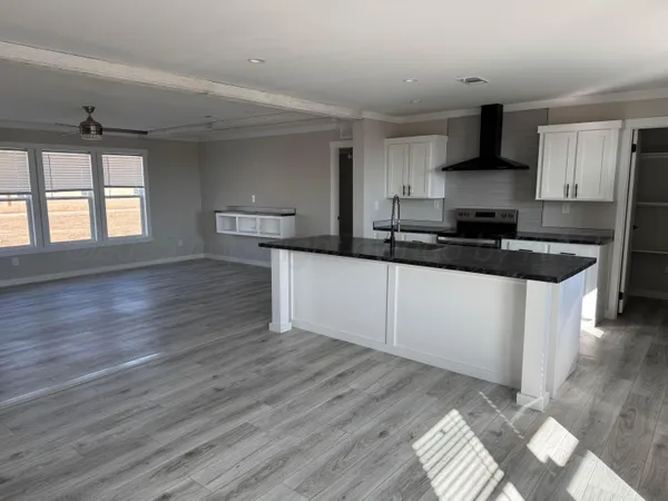 a view of kitchen with granite countertop cabinets and wooden floor