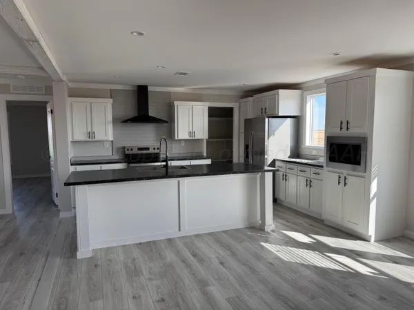 a kitchen with granite countertop a sink and a stove top oven