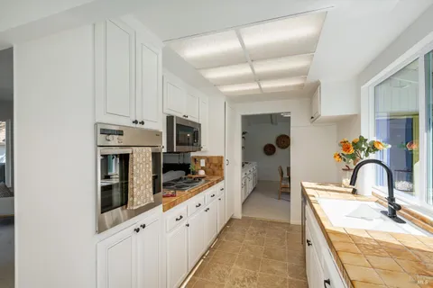 a bathroom with a granite countertop sink mirror and a shower