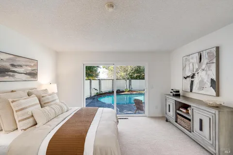 a bedroom with two beds and a large window