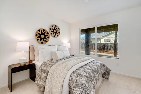 a bedroom with a bed and a large window