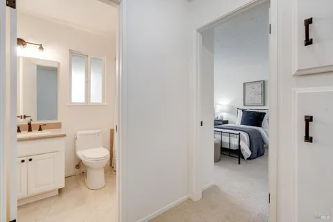 a bathroom with a toilet sink and a mirror