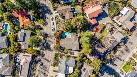 an aerial view of residential houses with outdoor space