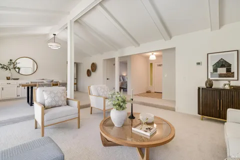 a living room with furniture a mirror and sink