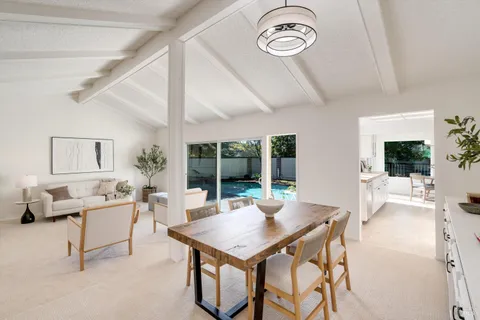 a kitchen with stainless steel appliances granite countertop a table and a sink
