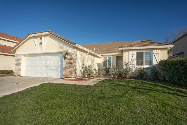 a front view of a house with a garden