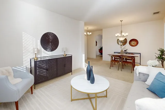 a living room with furniture a window and a lamp