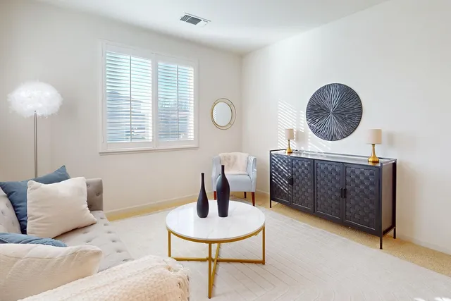a view of a dining room with furniture and chandelier
