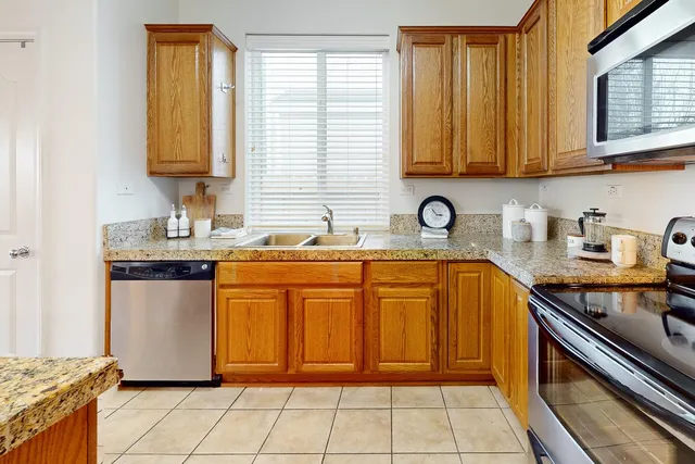 a large kitchen with a table and chairs in it