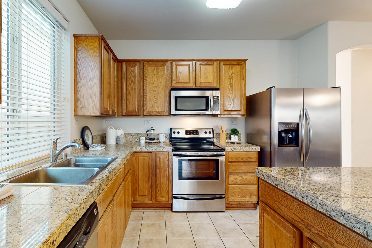 1920 Indiana Street Gridley, CA 95948 - Photo 29 of 66 a kitchen with stainless steel appliances granite countertop a sink a stove and a refrigerator