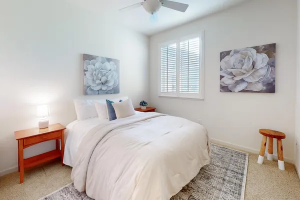 a backyard of a house with yard table and chairs