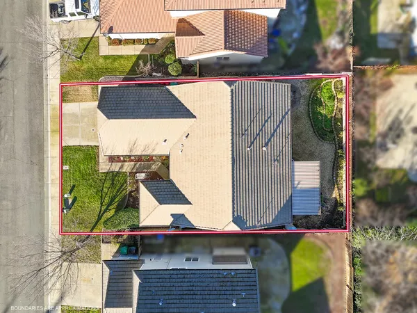 an aerial view of a house with a yard
