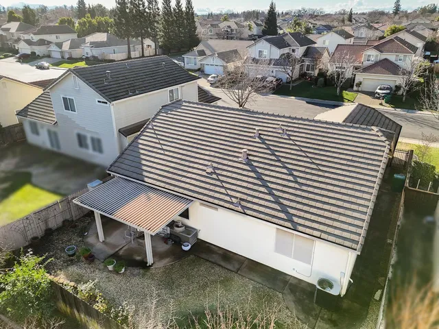 a front view of a house with a yard and potted plants