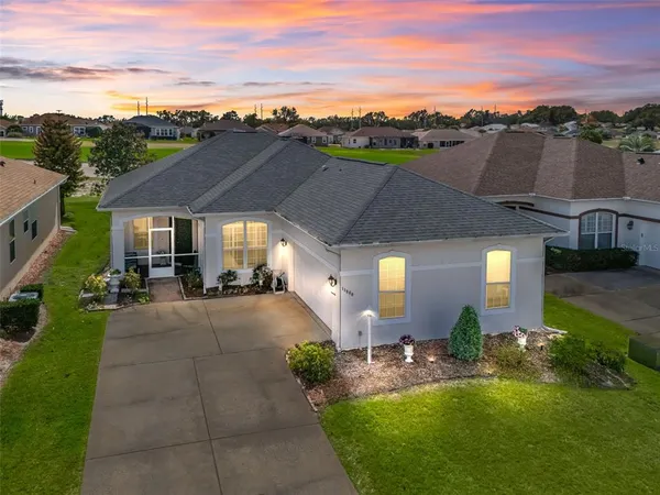 an aerial view of a house with swimming pool garden and outdoor seating