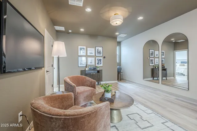 a living room with furniture and a potted plant