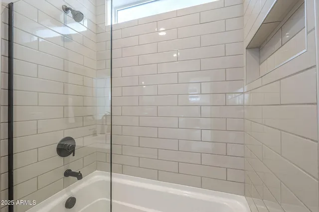 a bathroom with a bathtub and a shower