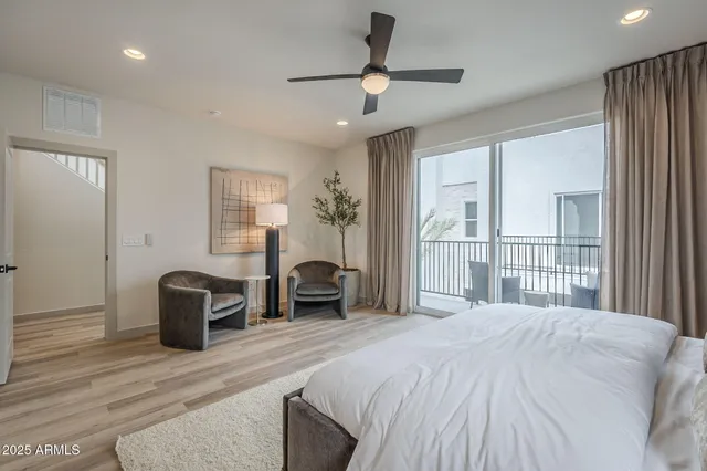 a bedroom with a large bed and a chandelier