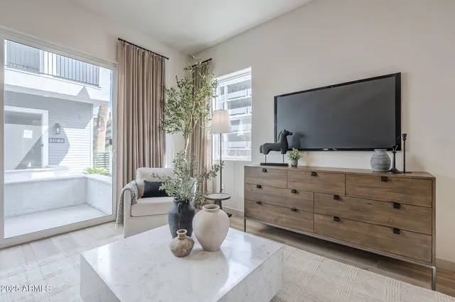 a living room with furniture and a flat screen tv