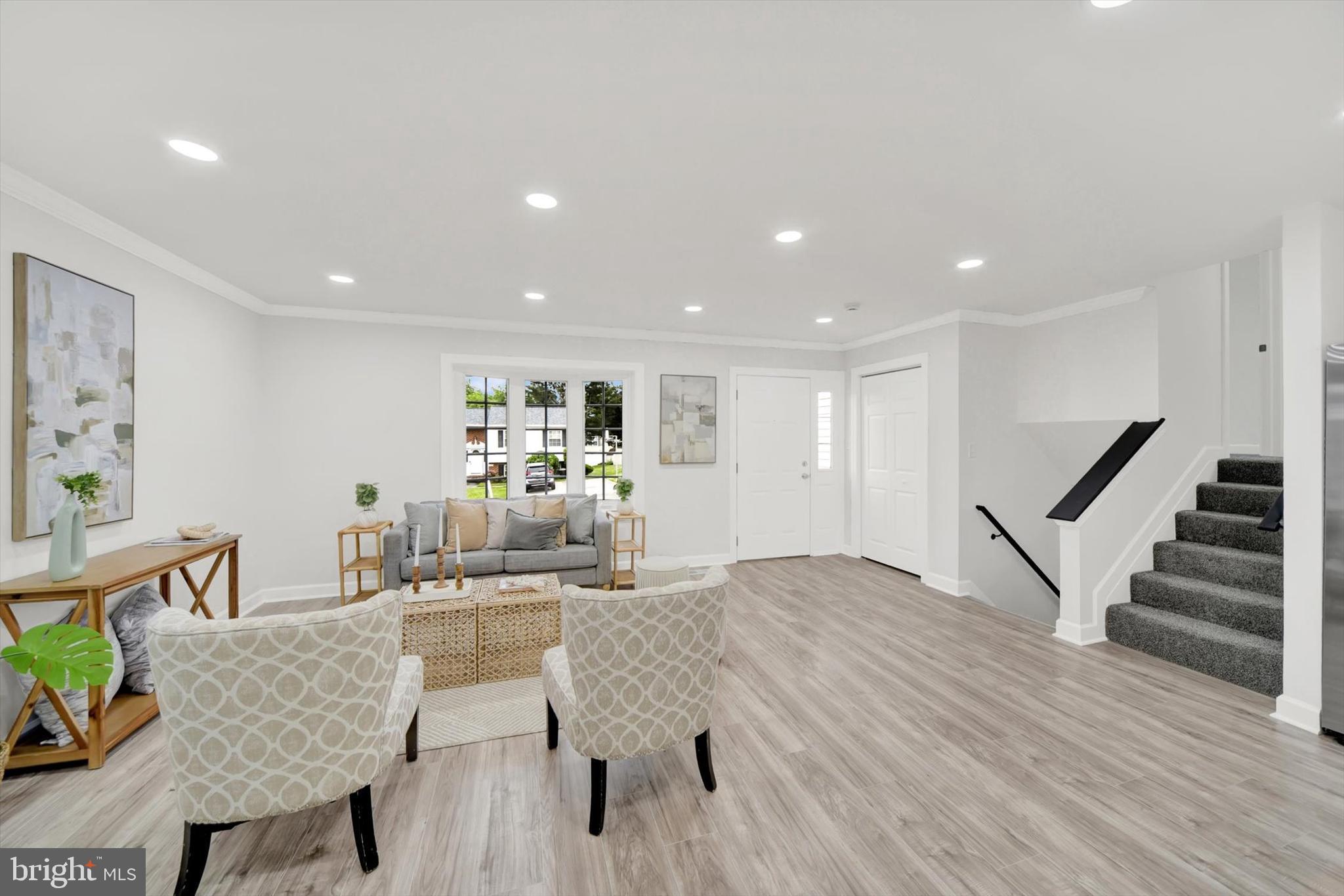 3808 Perryhurst Place Baltimore, MD 21236 - Photo 2 of 29 a living room with furniture and a wooden floor
