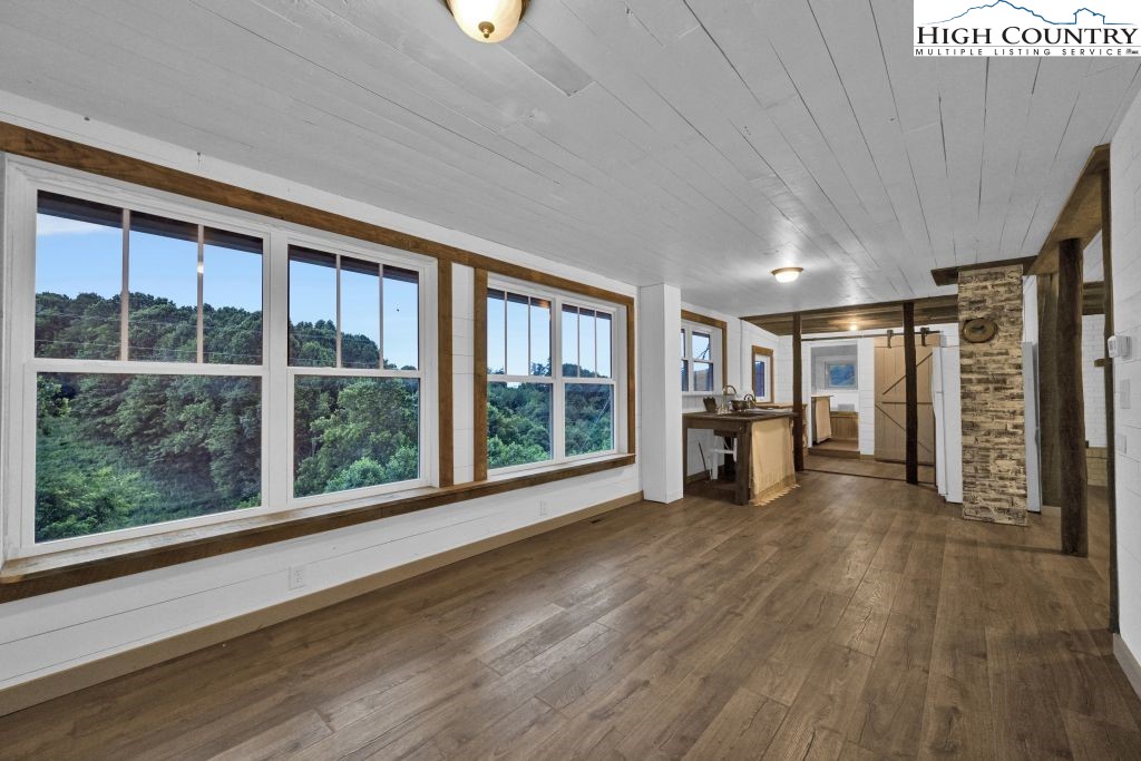 244 Flat Springs Road Elk Park, NC 28622 - Photo 11 of 47 a view of empty room with wooden floor and large window