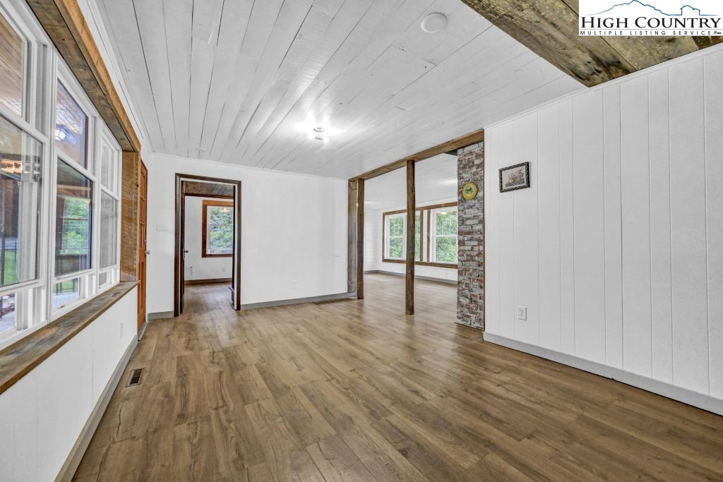 244 Flat Springs Road Elk Park, NC 28622 - Photo 15 of 47 a view of an empty room with wooden floor and a window