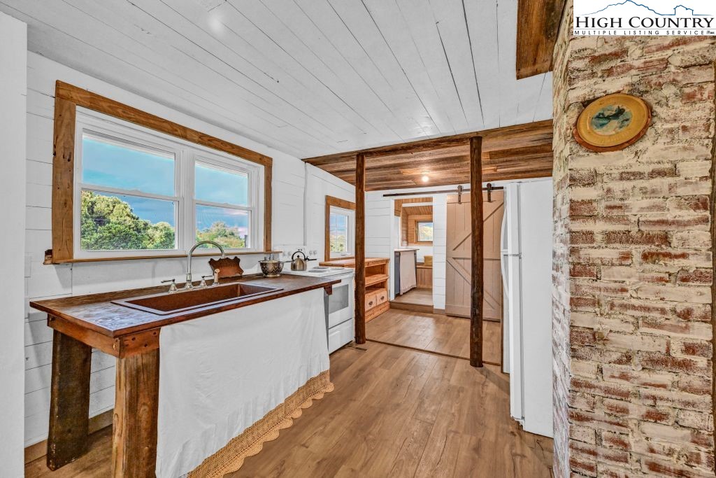 244 Flat Springs Road Elk Park, NC 28622 - Photo 16 of 47 a kitchen with stainless steel appliances granite countertop a refrigerator and a stove