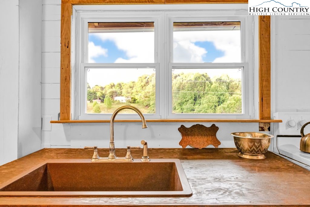 244 Flat Springs Road Elk Park, NC 28622 - Photo 17 of 47 a bathroom with a window sink and mirror