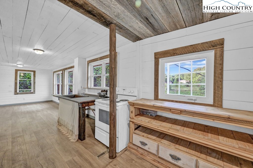 244 Flat Springs Road Elk Park, NC 28622 - Photo 18 of 47 a view of kitchen with furniture and large window