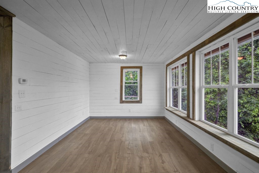 244 Flat Springs Road Elk Park, NC 28622 - Photo 20 of 47 a view of an empty room with a window and wooden floor
