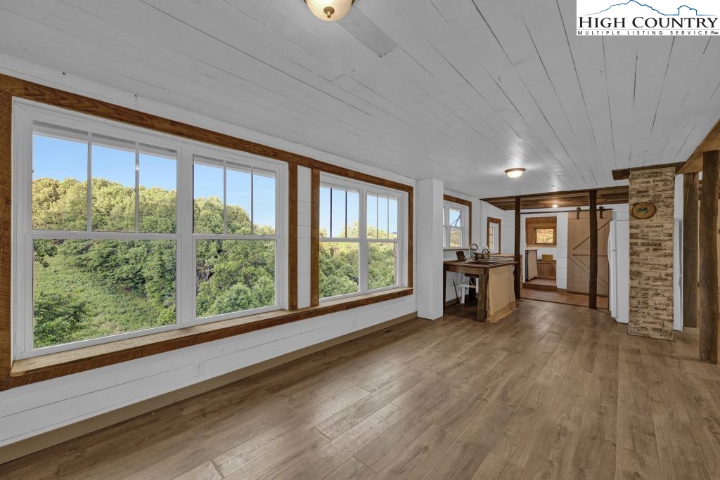 244 Flat Springs Road Elk Park, NC 28622 - Photo 24 of 47 a view of empty room with wooden floor and fan