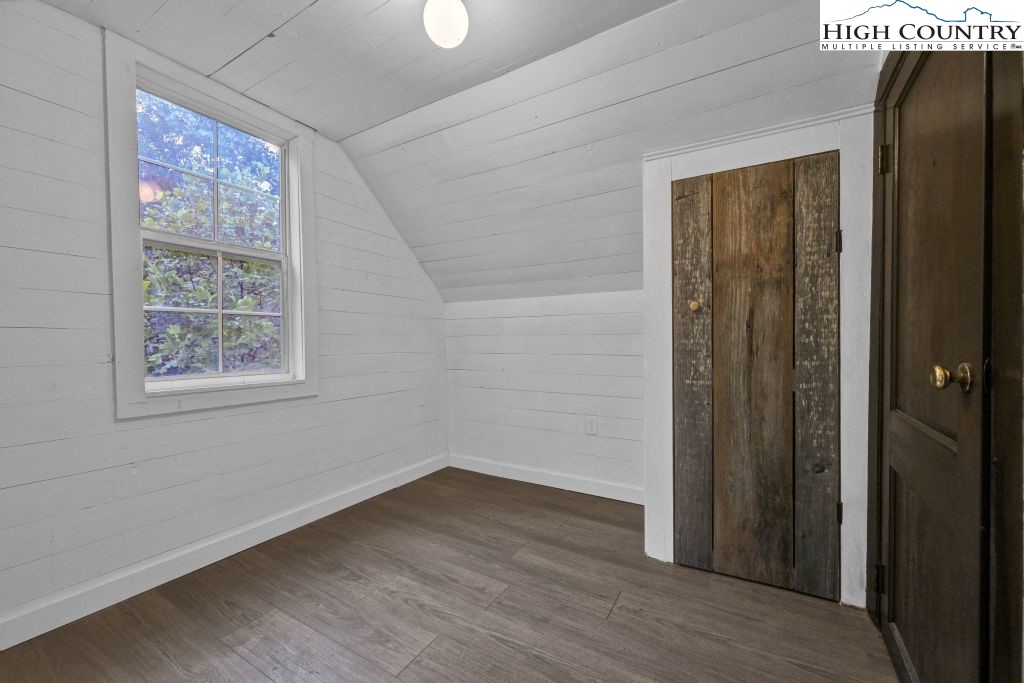 244 Flat Springs Road Elk Park, NC 28622 - Photo 35 of 47 an empty room with wooden floor and windows