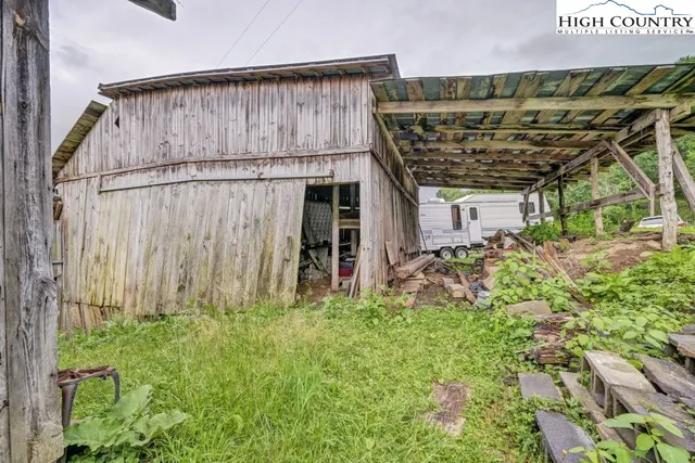 a backyard of a house with lots of green space and wooden fence