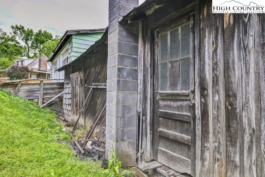 244 Flat Springs Road Elk Park, NC 28622 - Photo 43 of 47 a backyard of a house with lots of green space and wooden fence