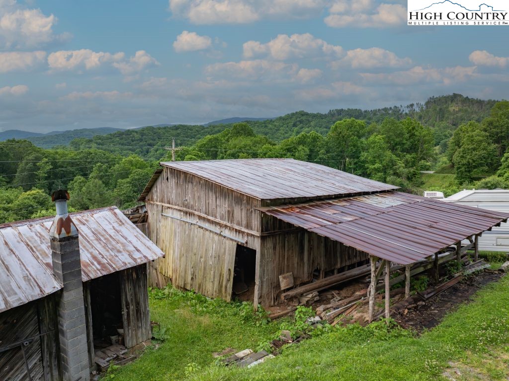 244 Flat Springs Road Elk Park, NC 28622 - Photo 44 of 47 a view of a barn with a table and a chairs