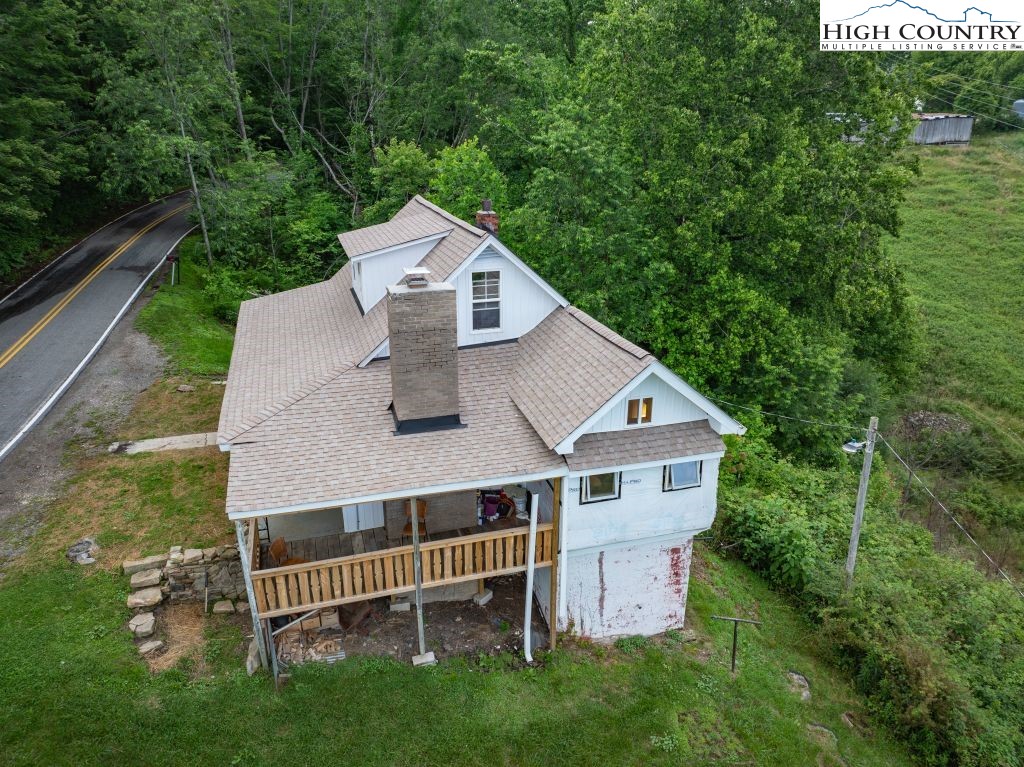 244 Flat Springs Road Elk Park, NC 28622 - Photo 46 of 47 a aerial view of a house with a yard and large trees
