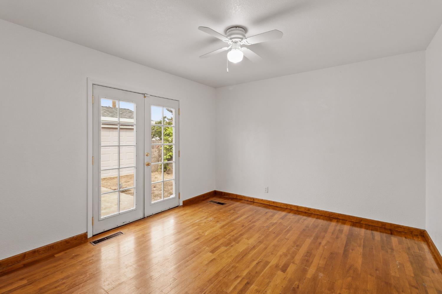 1805 Aloha Way Modesto, CA 95350 - Photo 13 of 24 an empty room with windows and ceiling fan