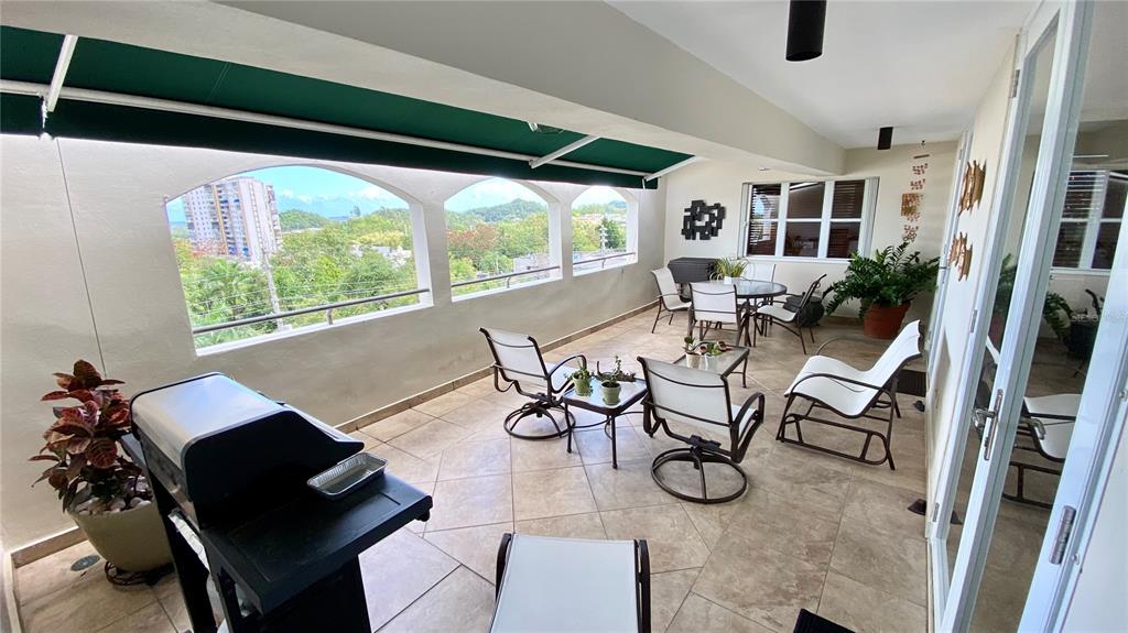 2 Cond Plaza, Unit PH6 Guaynabo, PR 00966 - Photo 1 of 1 a view of a dining room with furniture wooden floor and a chair