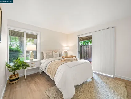 a bedroom with a bed and a potted plant