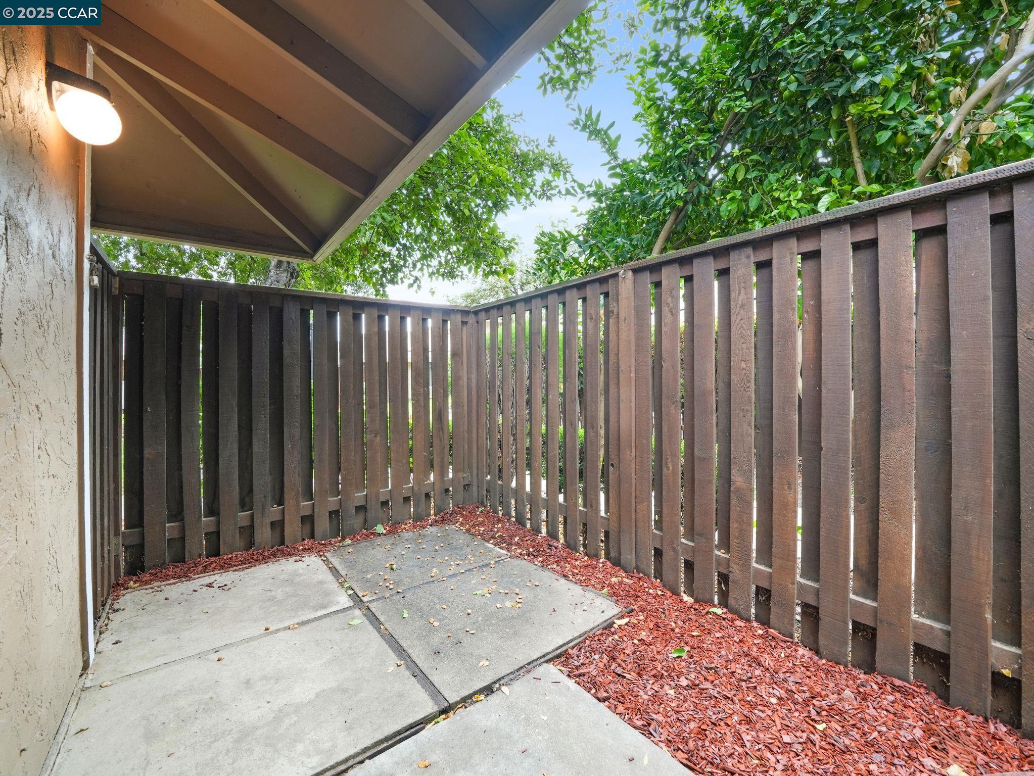 2011 Olivera Road, Unit D Concord, CA 94520 - Photo 15 of 24 a wooden fence with trees in front of it