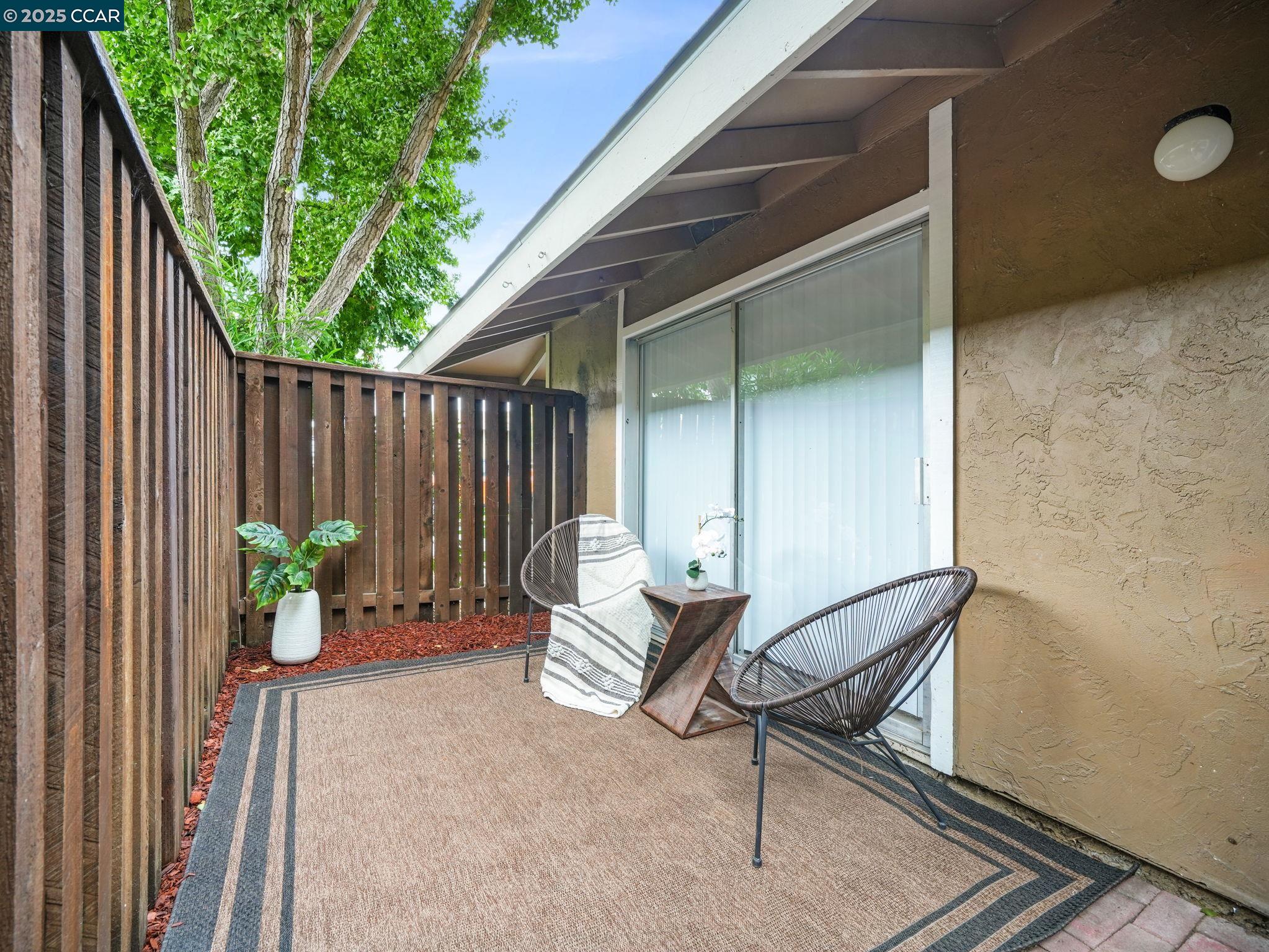 2011 Olivera Road, Unit D Concord, CA 94520 - Photo 16 of 24 a backyard of a house with chairs and a barbeque