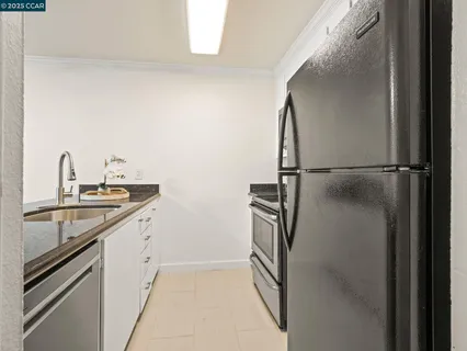 a kitchen with a sink and stainless steel appliances
