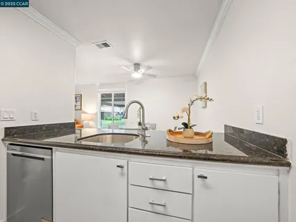 a kitchen with sink and mirror