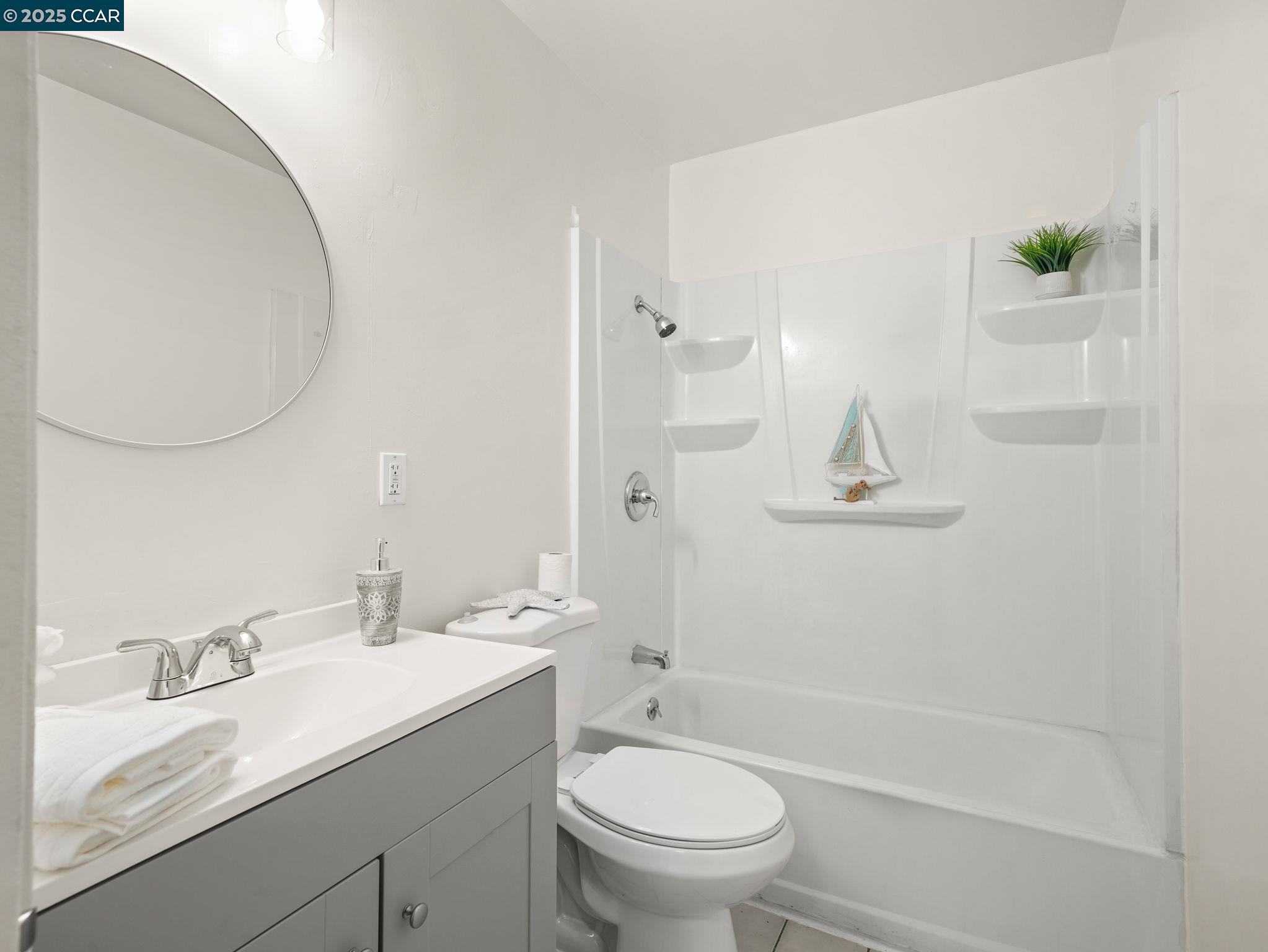 2011 Olivera Road, Unit D Concord, CA 94520 - Photo 10 of 24 a bathroom with a granite countertop sink a toilet and shower