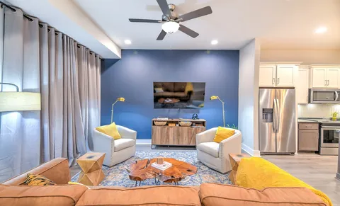 a living room with furniture and a flat screen tv