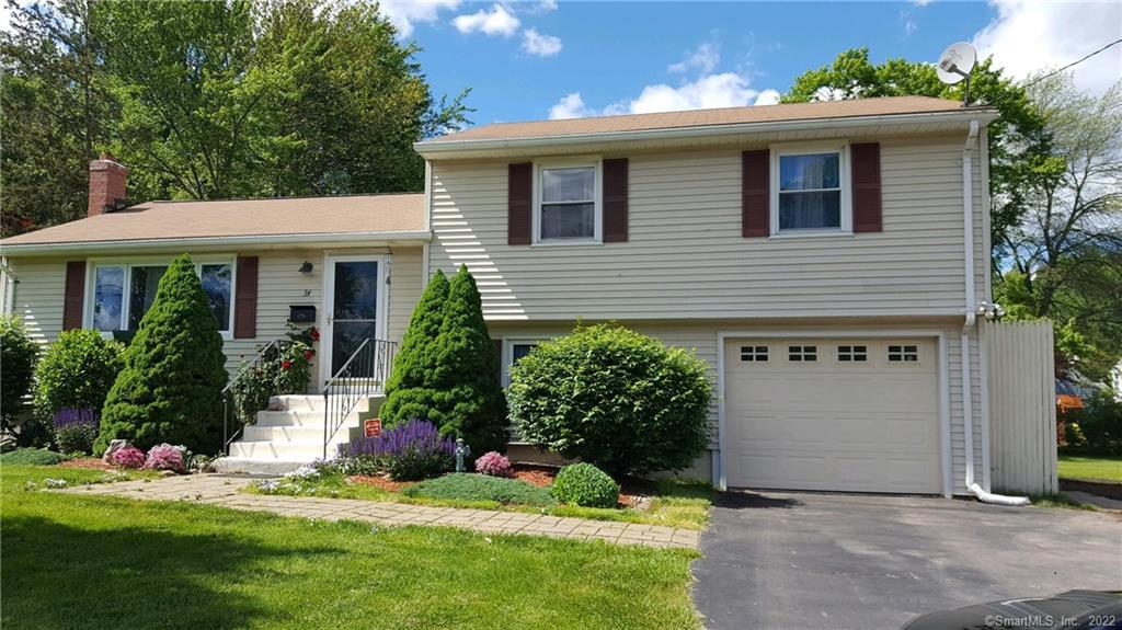 54 Brownleigh Road West Hartford, CT 06117 - Photo 1 of 1 a front view of a house with a yard and garage