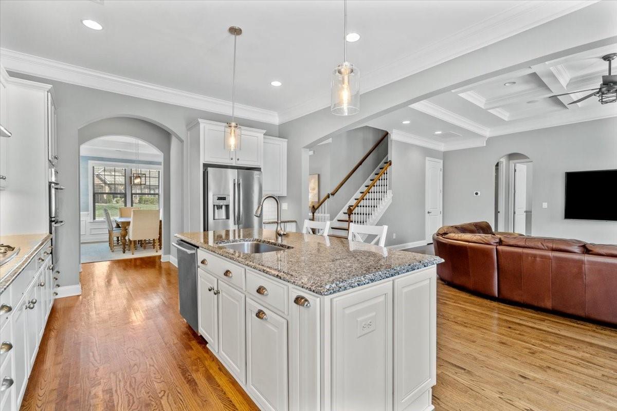 8131 Clems Branch Road Indian Land, SC 29707 - Photo 11 of 47 a view of living room with kitchen island stainless steel appliances wooden floor and living room view