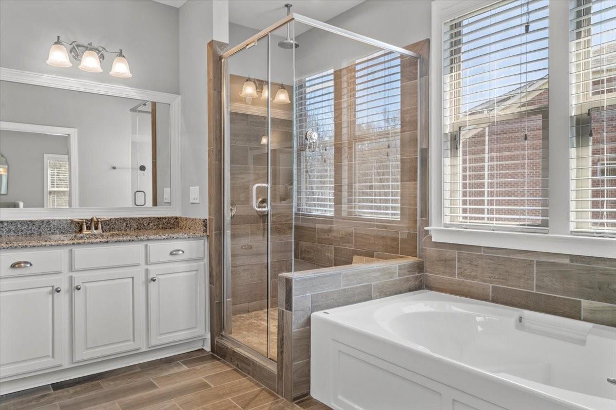 8131 Clems Branch Road Indian Land, SC 29707 - Photo 27 of 47 a bathroom with a granite countertop tub sink and mirror