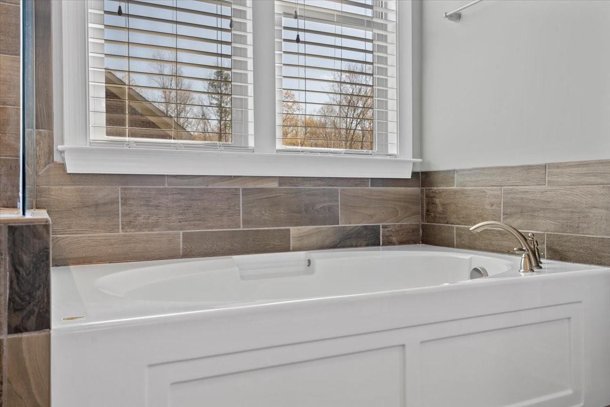 8131 Clems Branch Road Indian Land, SC 29707 - Photo 29 of 47 a bathroom with a bathtub and window