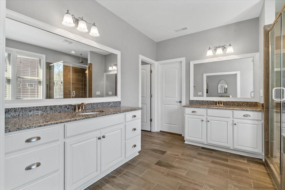 8131 Clems Branch Road Indian Land, SC 29707 - Photo 30 of 47 a spacious bathroom with a granite countertop sink mirror and double