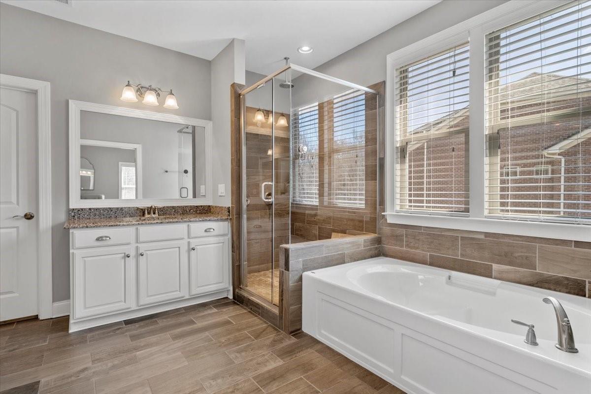 8131 Clems Branch Road Indian Land, SC 29707 - Photo 31 of 47 a spacious bathroom with a tub a sink and mirrors